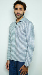 Man wearing a striped long-sleeve shirt against a plain background