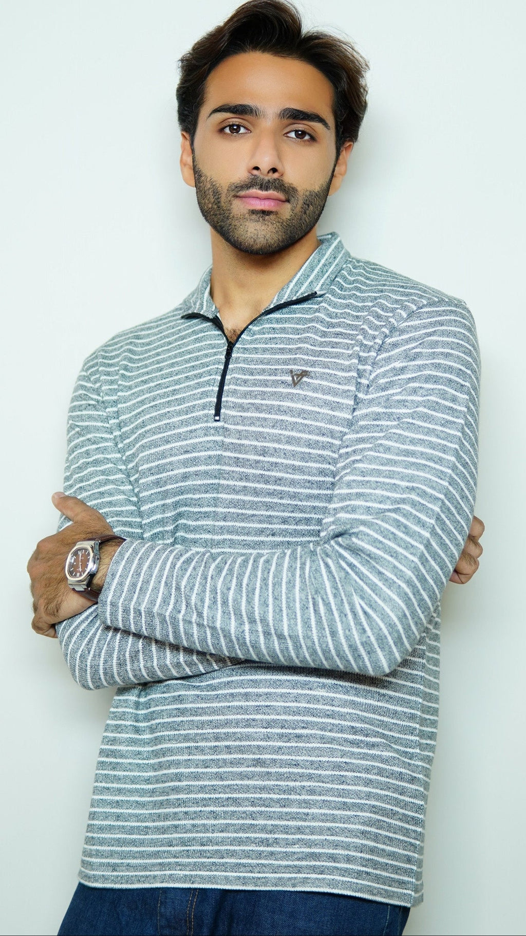 Man wearing a striped long-sleeve shirt against a white background