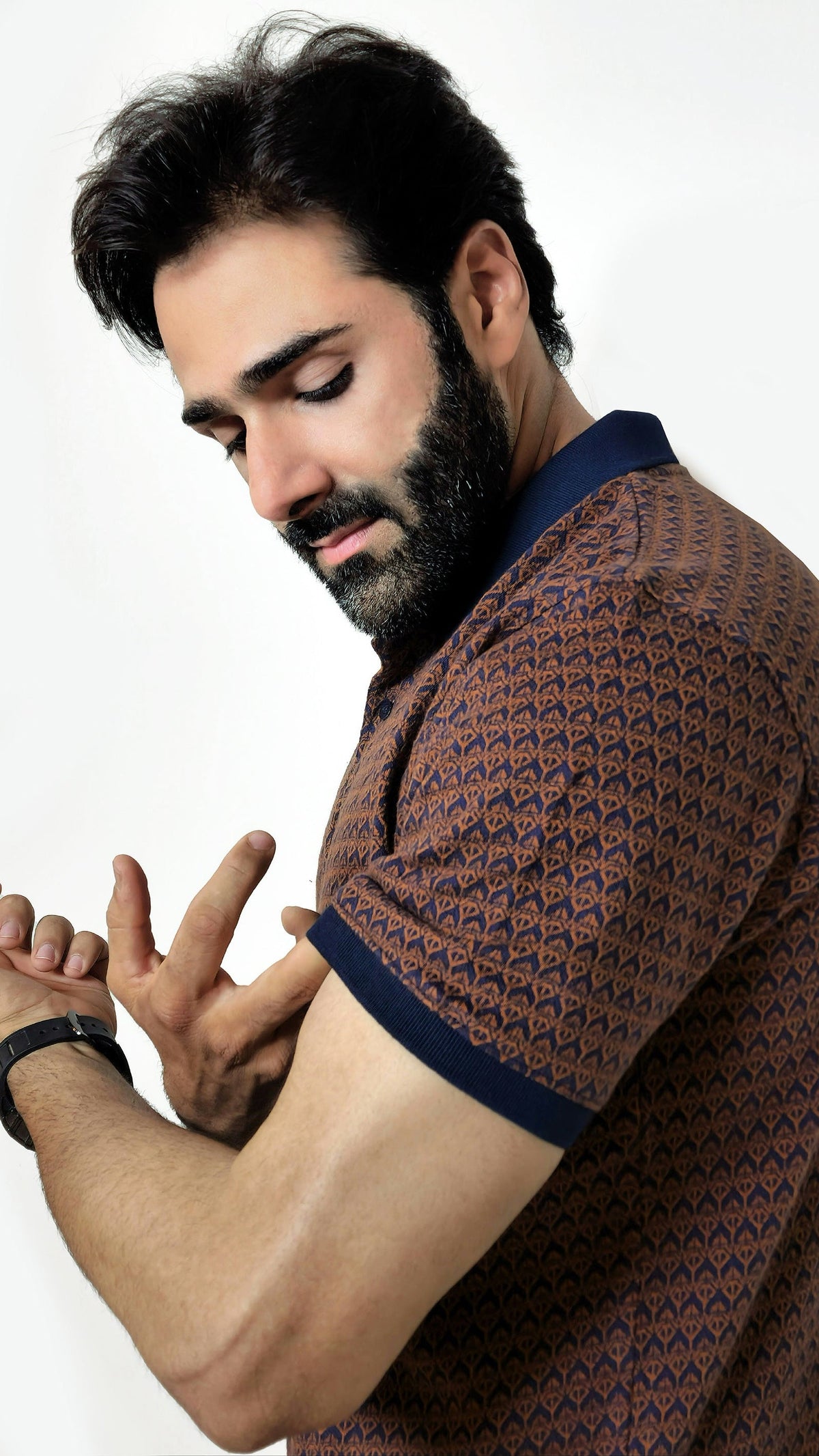 Man wearing a patterned shirt against a plain background