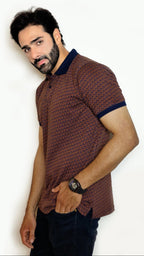 Man wearing a patterned shirt against a plain background